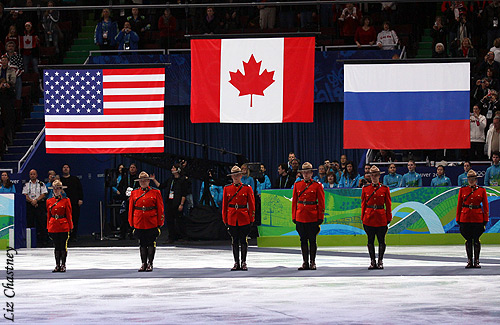 The Olympic ice dance champions' flags are raised