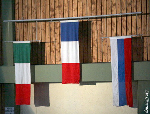 The flags of the medalists are raised