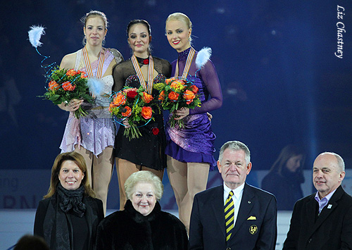 The event officials pose for a photo with the podium