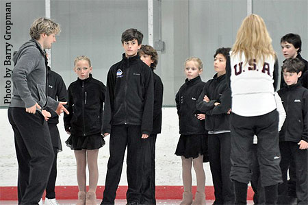The young ice dancers listen intently to White and Belbin's instruction