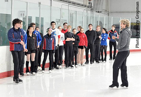Novice ice dancers line up and listen to White