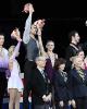 The pairs medalists wave from atop the podium.