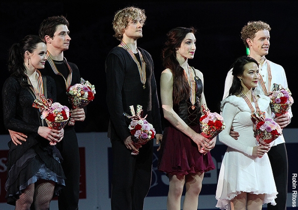 The skaters listen to the U.S. national anthem