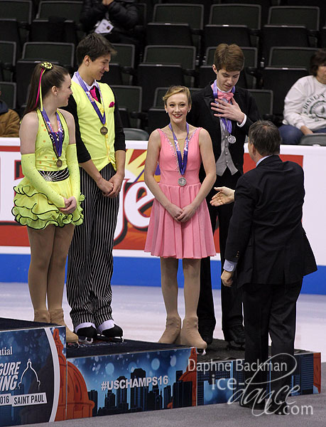 U.S. Figure Skating President Samuel Auxier congratulates the medalists